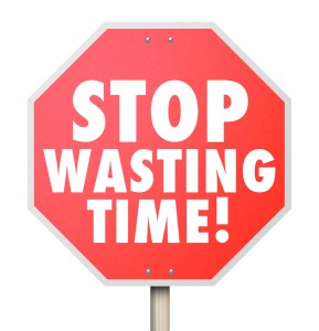 Stop Wasting Time words on a red road warning sign to help you better manage your hours and minutes for more efficiency and productivity